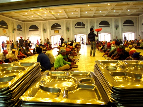 Pilgrims and visitors wait for their portions. 