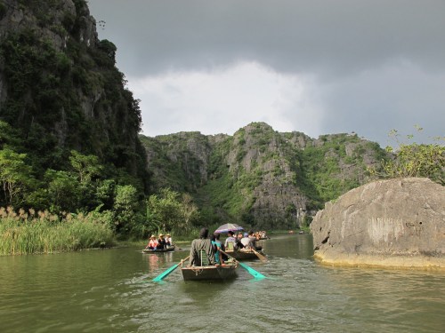 The Sampan Ride along the river hemmed by rice paddies, dotted by limestone rock formations. 